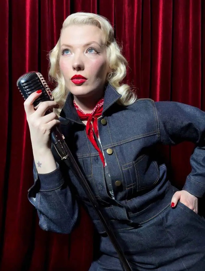 CC with a microphone wearingGolden Needle London Denim